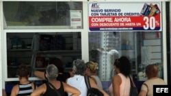 Fotografía de este 19 de septiembre de 2014 de Varias personas haciendo fila para comprar en un establecimiento en La Habana, Cuba. El largo tránsito hacia la unificación monetaria en Cuba ha dado ya un paso fundamental con la aceptación de pesos cubanos